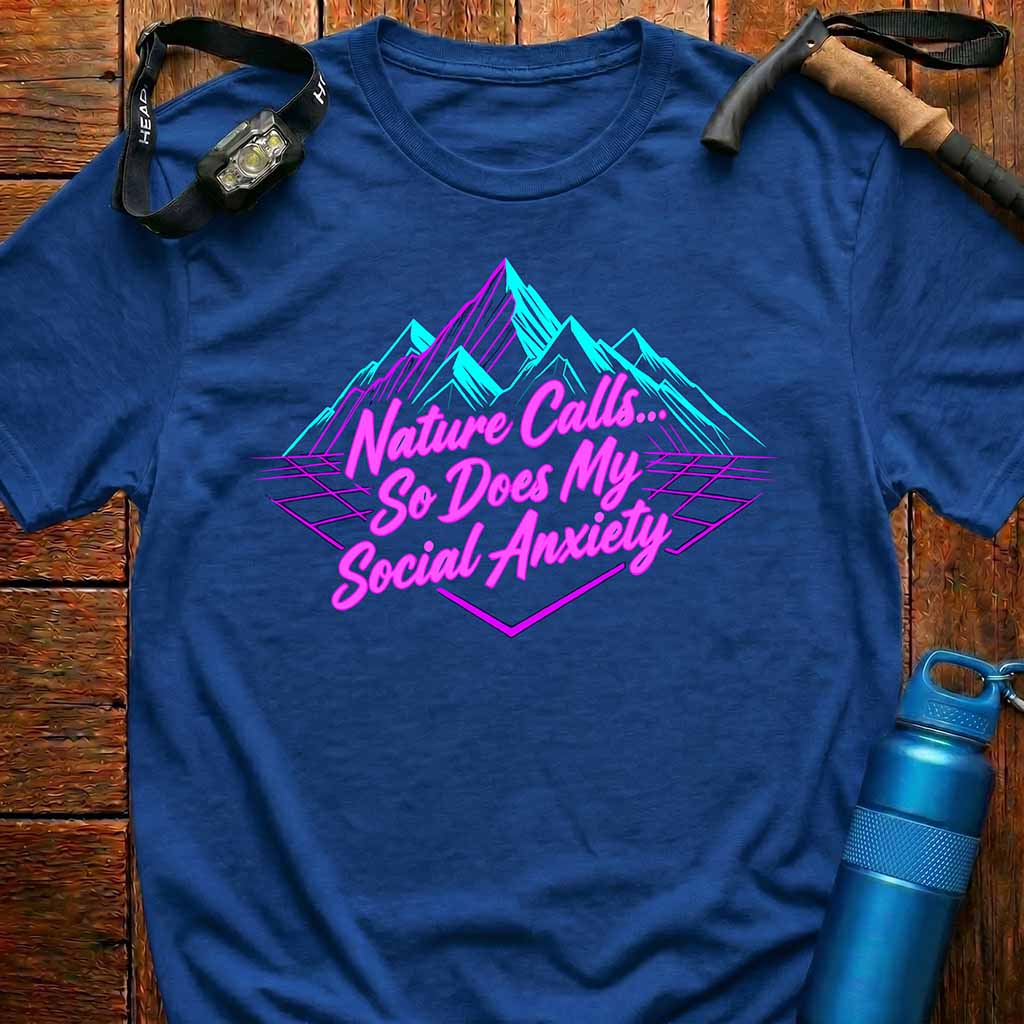Blue t-shirt with a humorous graphic and text on a wooden surface